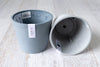 One blue Amsterdam ecopot upright one grey showing interior