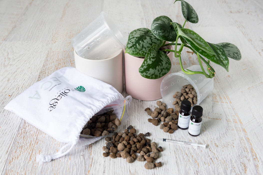 Semi hydro starter kit two clear plastic pots, two ceramic pots,, one pik other white, clay balls in Folaige Therapy calico bag, syringe, 15ml nutrient bottles and plant
