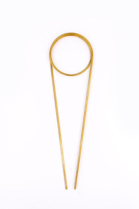 Brass plant totem on white background