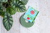 Velcro brand plant tie on white decorative surface next to plant